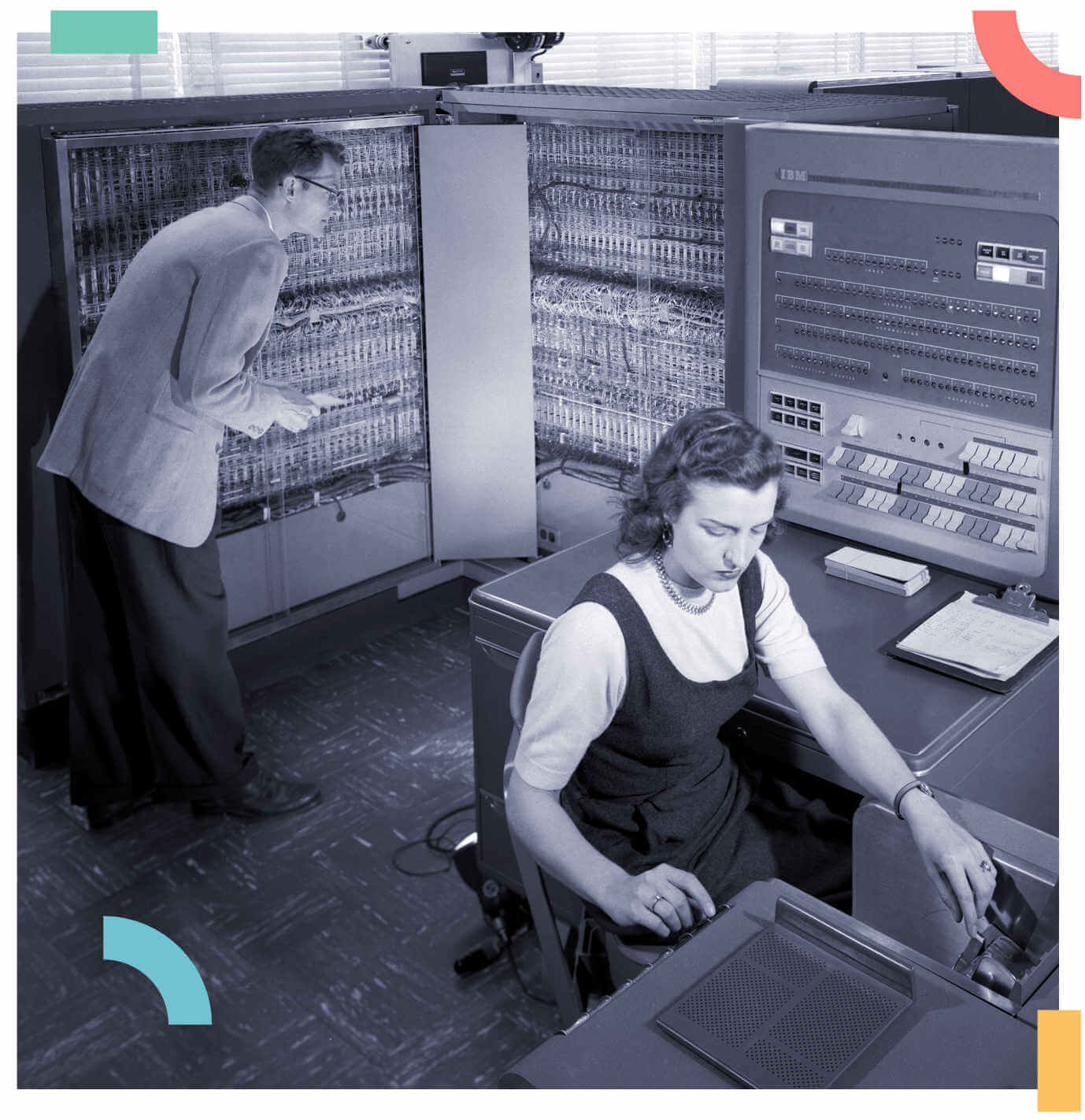 Image of a man and a woman working in a vintage computer lab